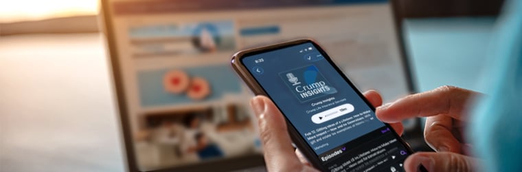 Computer and mobile phone displaying Crump app and website