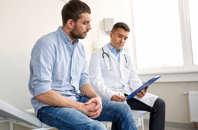 man sitting with a doctor