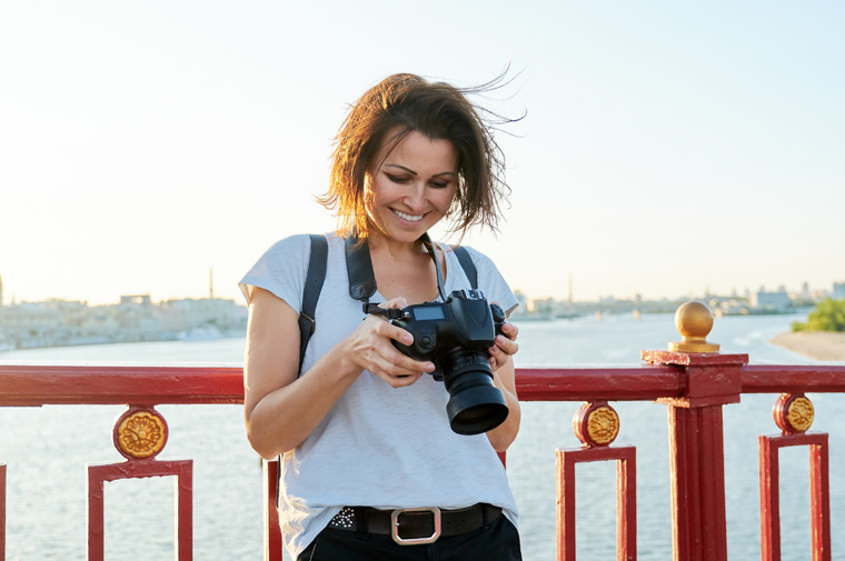 women traveling looking at her camera