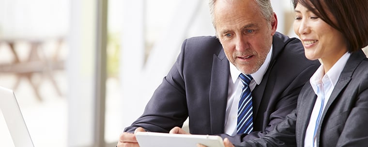 Business man and woman reviewing papers