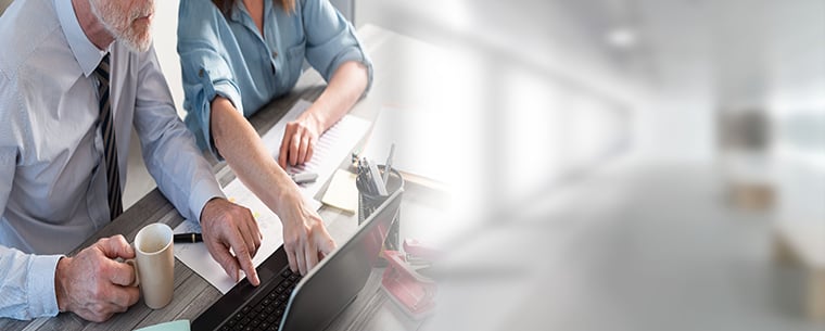 Man and woman looking at a laptop screen