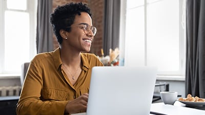 Joyful women sitting at laptop in home office
